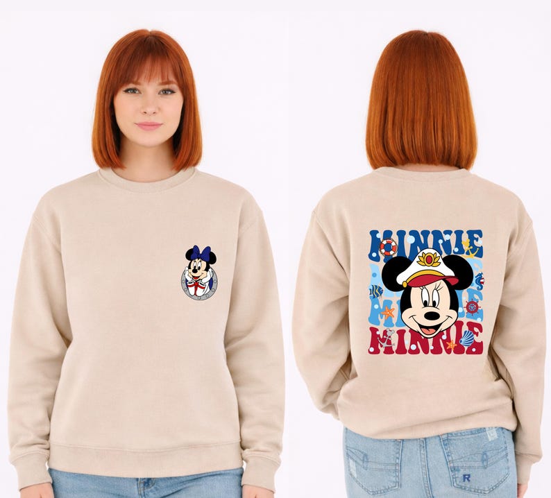 May include: Beige sweatshirt featuring a Minnie Mouse graphic on the front and back. The front graphic is a small Minnie Mouse in a sailor outfit. The back graphic says "Minnie" with a nautical theme, including a sailor hat and anchor.