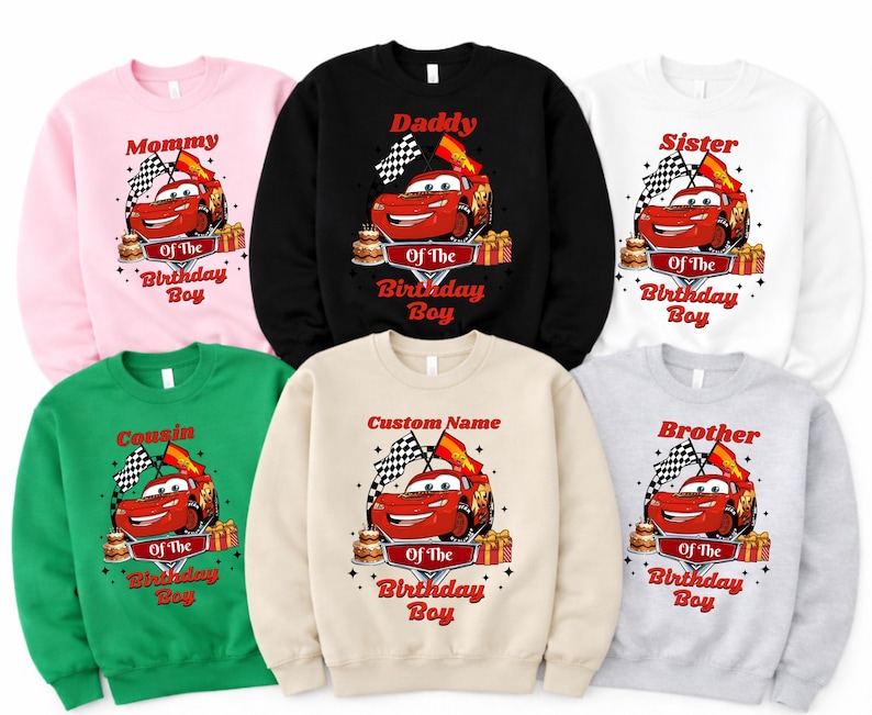 May include: A collection of sweatshirts in various colors, each featuring a red cartoon car graphic with the text "Mommy", "Daddy", "Sister", "Cousin", "Custom Name", and "Brother". The design includes checkered flags, a cake, and gift boxes.