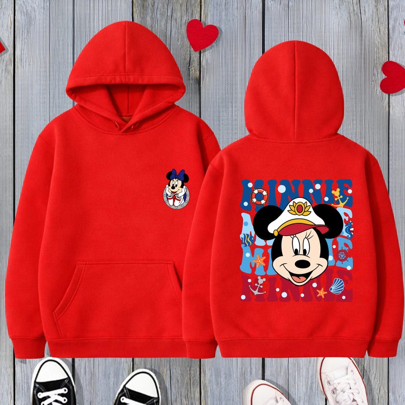May include: Red hooded sweatshirt featuring a Minnie Mouse graphic on the front and back. The front has a small Minnie Mouse emblem, while the back displays a larger nautical-themed Minnie Mouse design with the word "MINNIE".