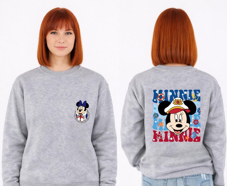 May include: A gray sweatshirt featuring Minnie Mouse. The front has a small Minnie Mouse graphic. The back displays a larger Minnie Mouse graphic with the word "MINNIE" in blue and red, surrounded by nautical elements.