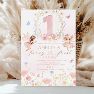 May include: A pink and white invitation for Amelia's first birthday. The design features a large number one, floral accents, and illustrations of fairies. The text reads "Please join us to celebrate Amelia's fairy first birthday."