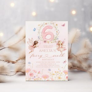 May include: A pink and white birthday invitation card with the number 6 in a floral wreath. The card features illustrations of fairies, butterflies, and flowers. Text on the card reads "Amelia's fairy sixth birthday".