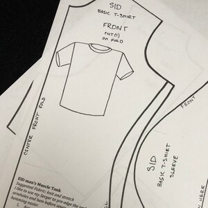 May include: A black and white sewing pattern for a basic t-shirt and muscle tank top. The pattern includes instructions for cutting and sewing the garment. The pattern is labeled "Sid" and includes instructions for lengthening or shortening the sleeve.