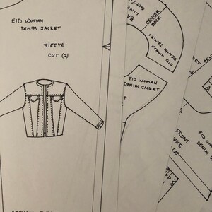 May include: A black and white line drawing of a denim jacket pattern with instructions for cutting and sewing. The pattern includes a sleeve, front yoke, and back pieces. The text on the pattern reads "EID Woman Denim Jacket".