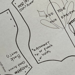 May include: A black and white pattern for a chest armor costume. The pattern includes instructions for adding grommets or punch holes, and a space to add your own emblem. The text on the pattern reads "MSD/450 Chest Armor" and "Add Your Own Emblem".