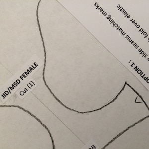 May include: A black and white sewing pattern for a garment labeled "JID/MSD FEMALE" with the instructions "Cut (1)" and "OPTION 1: A...sew side seams matching marks B...trim with fold over elastic ON 2: adding ¼".
