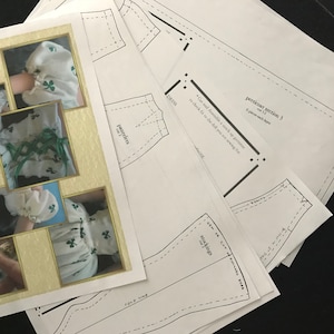 May include: A set of sewing patterns for a doll dress, petticoat, pantelets, and stockings. The patterns are printed on white paper and include instructions for cutting and assembling the garments.