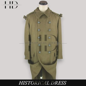 May include: An olive green double-breasted wool coat featuring a wide collar, shoulder epaulets with button details, and ten round buttons arranged in two vertical rows. The coat has two large front pockets and a long, structured silhouette.