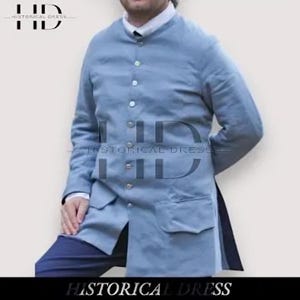 May include: A light blue long-sleeved coat featuring a high collar, a front button closure with multiple small buttons, and two large rectangular pockets on the lower front. The garment is worn over a white collared shirt and dark blue trousers.