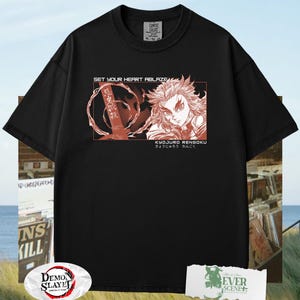 May include: Black t-shirt featuring a red graphic of a character with spiky hair and the text "SET YOUR HEART ABLAZE" and "KYOJURO RENGOKU" in a rectangular design. The shirt is a Comfort Colors brand.