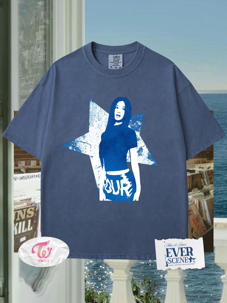May include: Blue Comfort Colors t-shirt with a blue graphic of a woman inside a white star. The word "OUR" is printed on the bottom of the graphic. The shirt has a crew neck and short sleeves. The tag says XL-70-10.