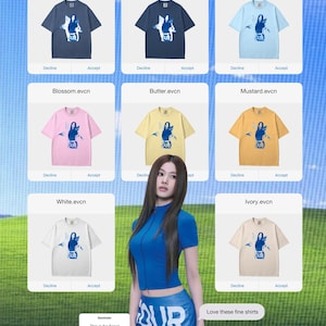 May include: A selection of t-shirts in shades like denim, navy, light blue, pink, yellow, orange, white, and cream. Each shirt displays a graphic and the word "PUR". The image also shows a woman in blue clothing and the text "Love these fine shirts".