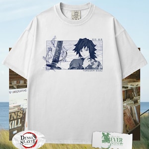 May include: White t-shirt with a blue illustration of Tomioka Giyu from Demon Slayer. The graphic includes Japanese text and a sword design. The shirt has a crew neck and short sleeves. The shirt is a Comfort Colors XL-TG-XXL.