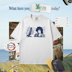 May include: White t-shirt with a blue anime graphic and the text "TORIOKA SIMU". The image also shows a tote bag, cassette player, and trainers, creating a casual, lifestyle aesthetic.