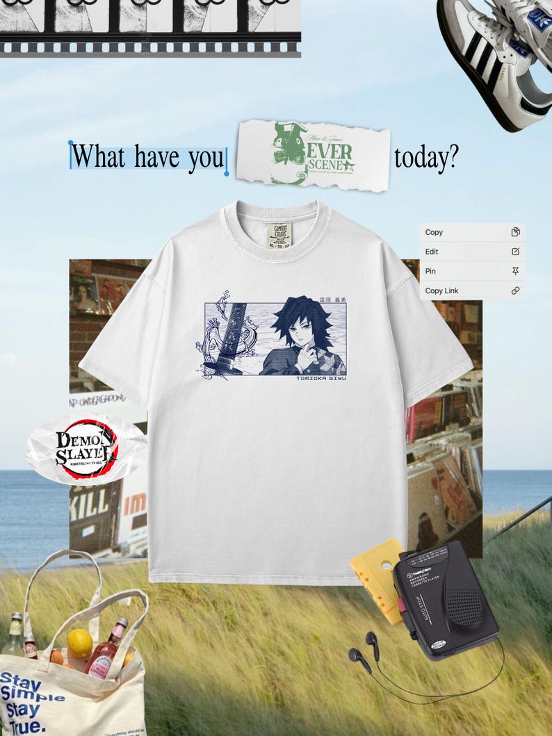 May include: White t-shirt with a blue anime graphic and the text "TORIOKA SIMU". The image also shows a tote bag, cassette player, and trainers, creating a casual, lifestyle aesthetic.