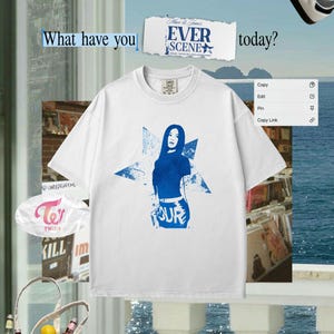 May include: White t-shirt featuring a blue graphic of a woman and a star, with the word "FOUR" below. The image also includes the text "What have you" and "EVER SCENE today?"