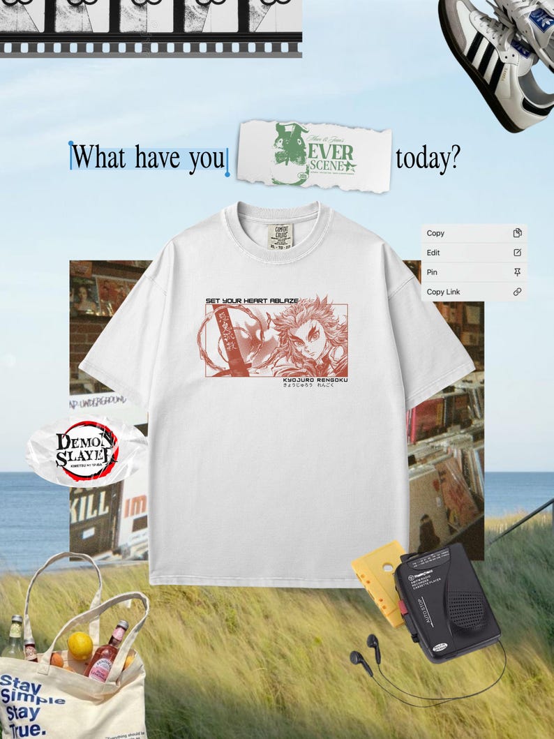 May include: White t-shirt featuring a red graphic of a character with the text "SET YOUR HEART ABLAZE" and Japanese text. The image includes a cassette player, headphones, and a tote bag with text. The background is a light blue sky.