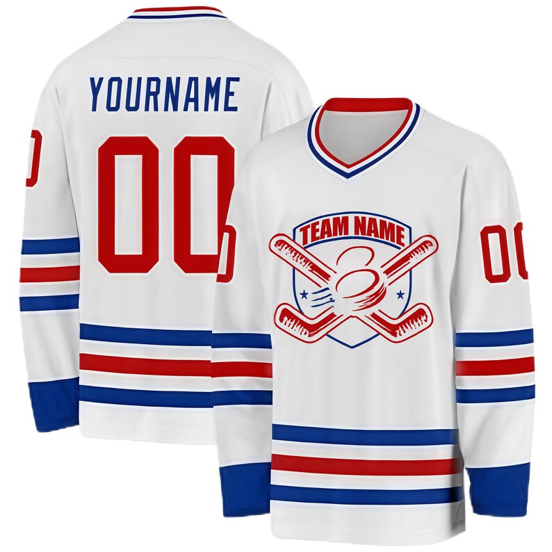 May include: White hockey jersey with red and blue accents. The jersey features the text "YOURNAME" and the number "00" on the back. The front displays a team logo with crossed hockey sticks and the text "TEAM NAME".