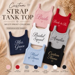May include: A collection of seven ribbed tank tops in pink, red, white, grey, navy, light blue, and black. Each top features custom text including Bride, Bride-to-Be, Bridal Squad, Amelia, Mrs. Grace, Maid of Honor, and Custom Name with hearts.