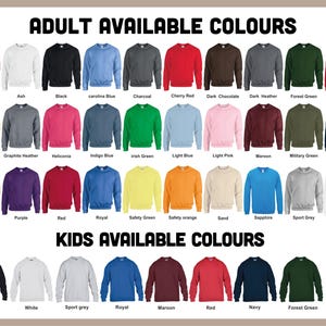 May include: A display of crewneck sweatshirts in various colors, including red, blue, and green, with the text "ADULT AVAILABLE COLOURS" and "KIDS AVAILABLE COLOURS" at the top and bottom. The sweatshirts are arranged in rows, showcasing a wide range of color options.