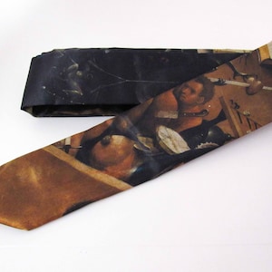 May include: A necktie featuring a detailed print of a painting with a brown and black color scheme. The artwork depicts a figure in a room with various objects. The tie is folded and lies on a white surface.