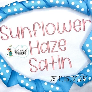 May include: Embroidered design of the words "Sunflower Haze Satin" in pink thread on a white fabric background. The design is surrounded by a blue ribbon with white polka dots. The sizes of the design are shown as 0.75 inches, 1 inch, 1.5 inches, 2 inches, and 2.5 inches.