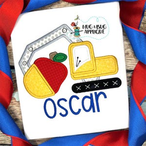 May include: White t-shirt featuring an applique design of a yellow and gray excavator scooping a red and yellow apple. The name "Oscar" is embroidered in blue. The text "HUG A BUG APPLIQUE" is also present.