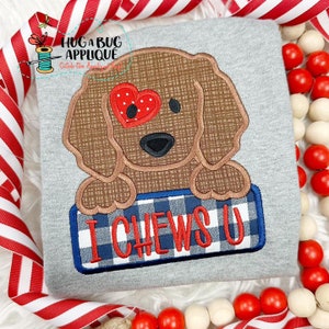 May include: A brown dog with a red heart over one eye is holding a blue and white checked sign that says "I CHEWS U".