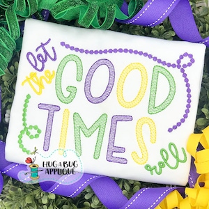 May include: White t-shirt with embroidered text "Let the good times roll" in green, yellow, and purple thread. The text is surrounded by a line of purple beads.