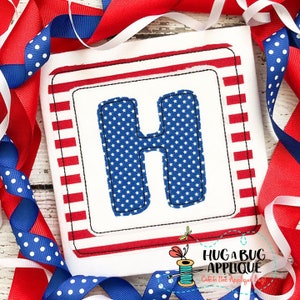 May include: A red, white, and blue applique design featuring the letter H. The letter is filled with a blue and white star pattern and outlined in black. The design is surrounded by a red, white, and blue striped border.