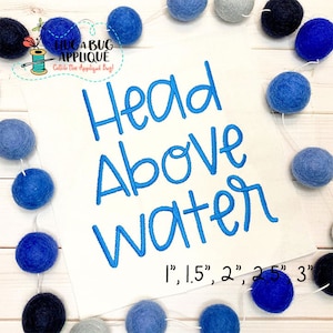 May include: Embroidered design of the phrase "Head Above Water" in blue thread on a white fabric background. The design is available in sizes 1, 1.5, 2, 2.5, and 3 inches.