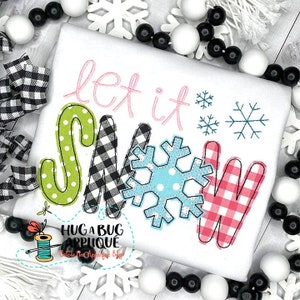 May include: White t-shirt with the phrase "let it snow" in pink script and colorful block letters. The letters are green with white polka dots, black and white checkered, light blue with white polka dots, and red and white checkered.