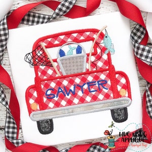 May include: Red truck with a white and red checkered pattern, filled with fishing gear, including a fishing net, fishing poles, and a bucket with fish. The truck has the name "SAWYER" written on the back.