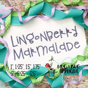 May include: Embroidered design for a sewing project, featuring the text "Lingonberry Marmalade" in a handwritten font. The design is available in sizes 1 inch, 1.25 inches, 1.5 inches, 1.75 inches, 2 inches, 2.25 inches, and 2.5 inches.
