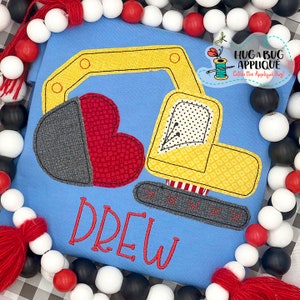 May include: A blue baby onesie with a yellow embroidered excavator, a red and gray heart, and the name "Drew" embroidered in red.