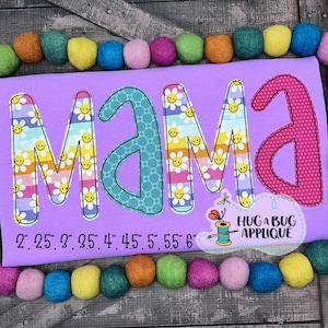 May include: Purple fabric with the word "mama" in colorful embroidered letters. The letters are decorated with a daisy pattern. The fabric is marked with measurements from 2 to 6 inches.