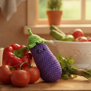 May include: A wooden cutting board displays a red bell pepper, tomatoes, and a crocheted purple eggplant with a green stem. A white colander holds fresh vegetables. A mug of hot beverage steams in the background. A kitchen scene.