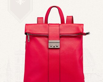 May include: A bright red leather backpack with a top handle and adjustable shoulder straps. The bag features a silver-tone clasp and zipper closure. The text "VITA DI LUSSO" is visible at the top. This stylish backpack is perfect for everyday use.