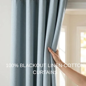 May include: Light blue blackout linen-cotton curtains. The curtains are hanging from a rod and are being held open by a hand. The text on the image reads "100% BLACKOUT LINEN-COTTON CURTAINS."