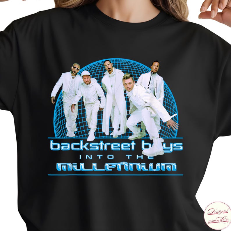 May include: A black t-shirt featuring a graphic of the Backstreet Boys in white outfits standing in front of a blue grid sphere. The text reads "backstreet boys" and "INTO THE MILLENNIUM" in a stylized blue font with a metallic appearance.