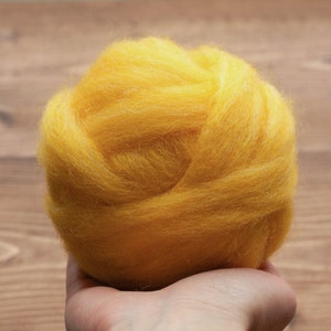 May include: A ball of bright yellow wool fiber, perfect for felting or spinning.