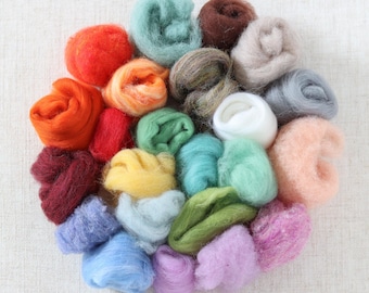 May include: A collection of 20 different colors of wool roving, arranged in a circle. The wool is soft and fluffy, and the colors are vibrant and varied.