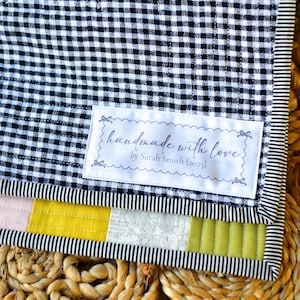 Sew-in label with scalloped border and delicate script font