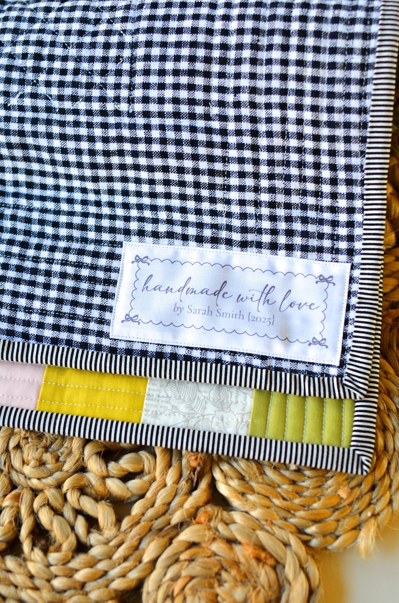 Sew-in label with scalloped border and delicate script font