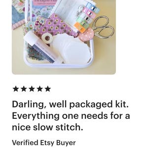 May include: A white rectangular box filled with sewing supplies, including fabric scraps, scissors, clips, and a glue stick. The box contains a booklet titled "Hexagon Flower". The kit is designed for slow stitch projects.