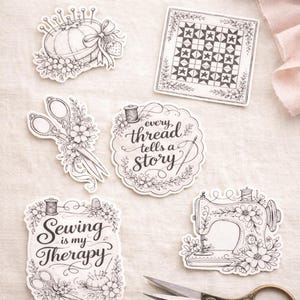 May include: A collection of black and white sewing-themed stickers. Designs include a pincushion, scissors, a quilt block, a sewing machine, and quotes like "Every thread tells a story" and "Sewing is my therapy."