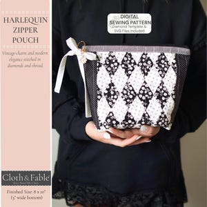 May include: A black and white harlequin zipper pouch with a diamond pattern, featuring floral accents. The pouch has a white ribbon and a gold-colored ring. The text on the pouch reads "HARLEQUIN ZIPPER POUCH". The finished size is 8 x 10 inches.