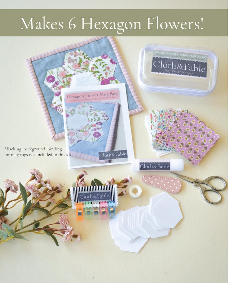 May include: A craft kit for making hexagon flower mug rugs. The kit includes fabric, paper pieces, clips, scissors, and a glue stick. The text on the packaging reads "Makes 6 Hexagon Flowers!" and "Cloth & Fable".