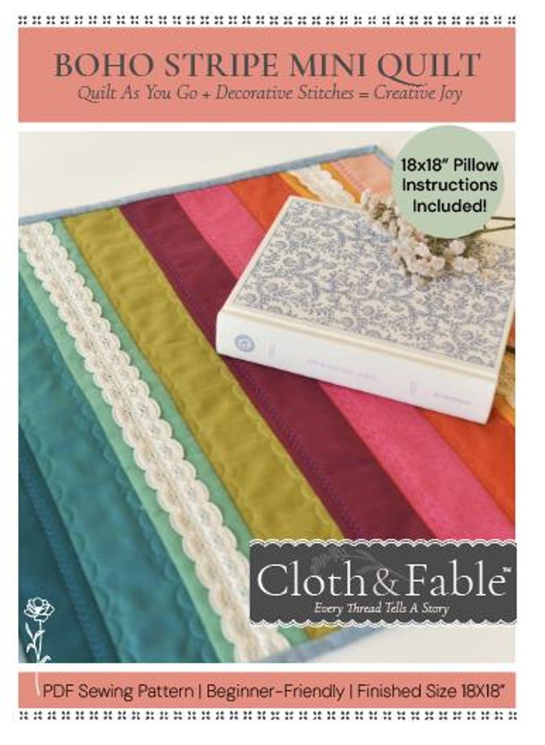 May include: A colorful Boho Stripe Mini Quilt with a striped design in teal, green, burgundy, pink, and orange. The quilt is accented with white lace trim. A book with a floral pattern and the text "Cloth & Fable" is on top of the quilt. Finished size is 18x18 inches.