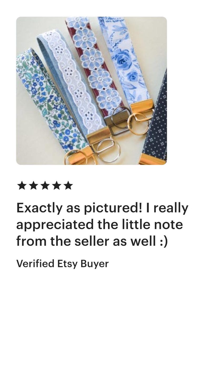 May include: A collection of fabric key fobs in various patterns, including floral and lace designs. Each fob features a gold-toned metal clasp for attaching keys. The image shows a variety of colors, including blue, white, and burgundy.